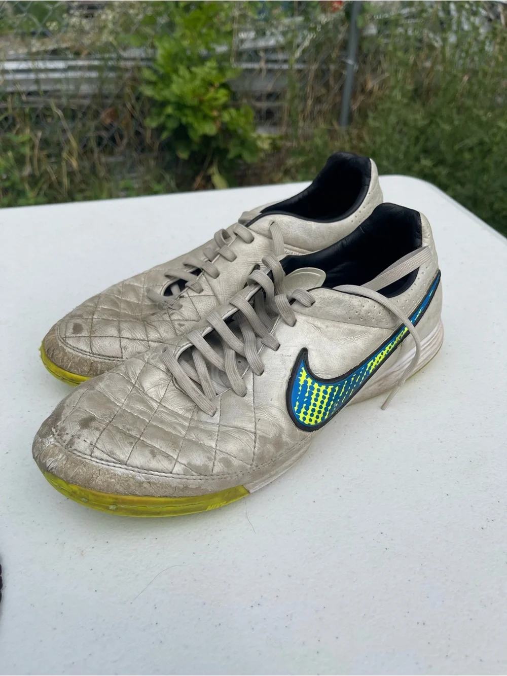 Nike Men’s Silver Athletic Shoes with Blue and Yellow Swoosh